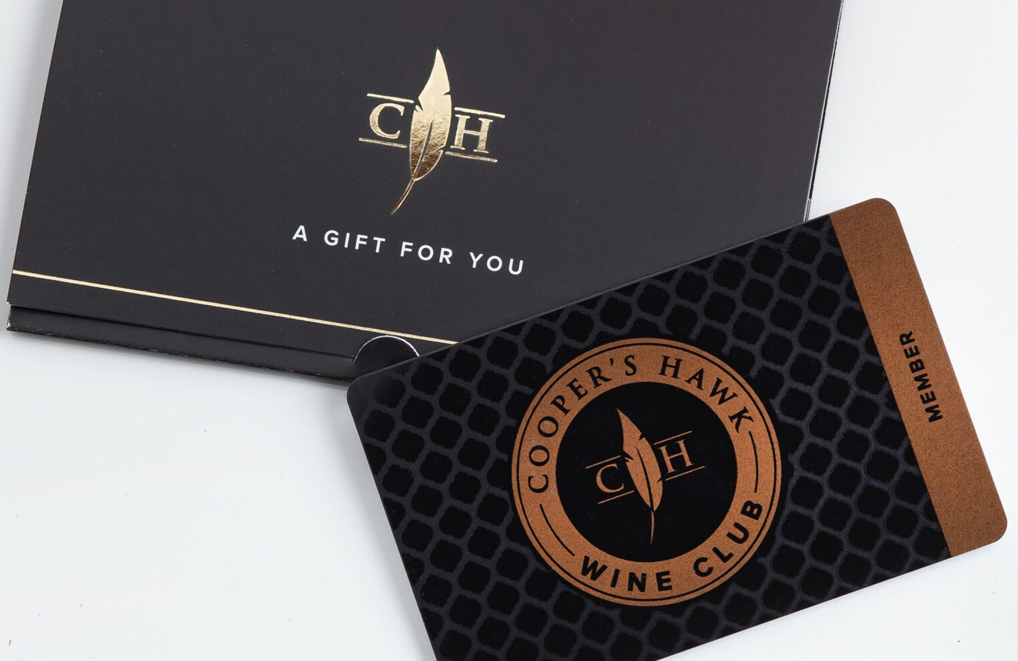 A gift card with a bottle of wine next to it.