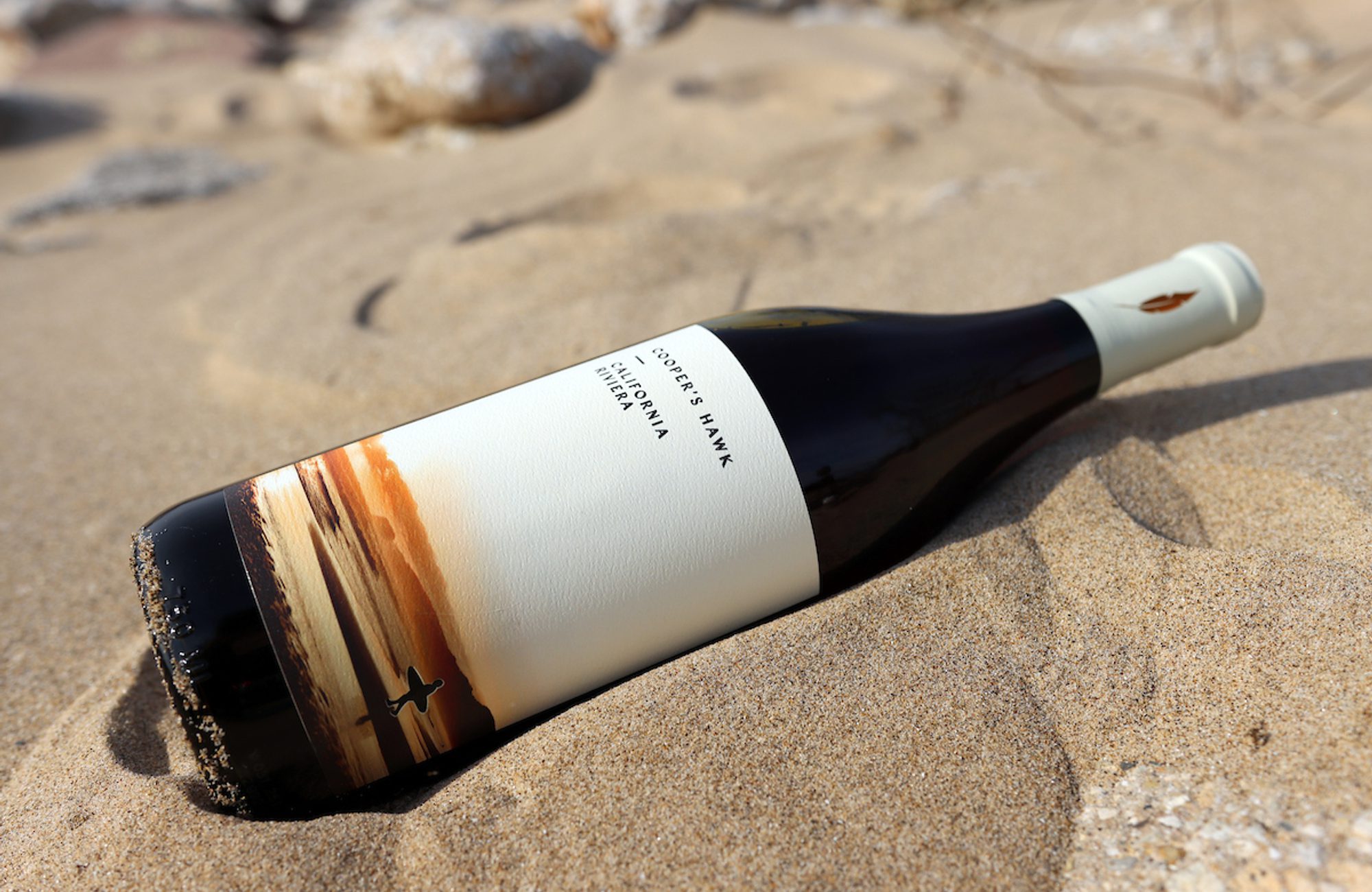 California Riviera Bottle Image with background of the beach