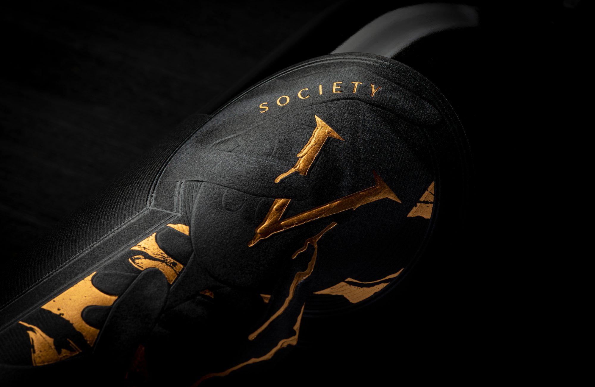 A bottle of wine with a gold logo on it.