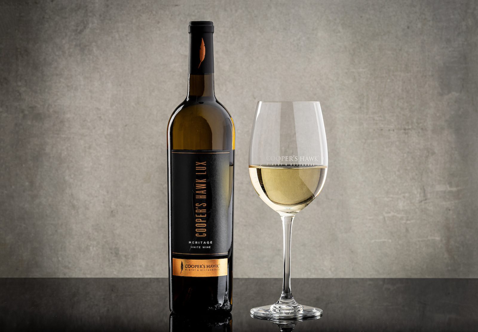 Image of Meritage wine bottle with glass of wine next to it