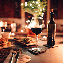 January WC Dinner Image with glass of wine and bottle on the table