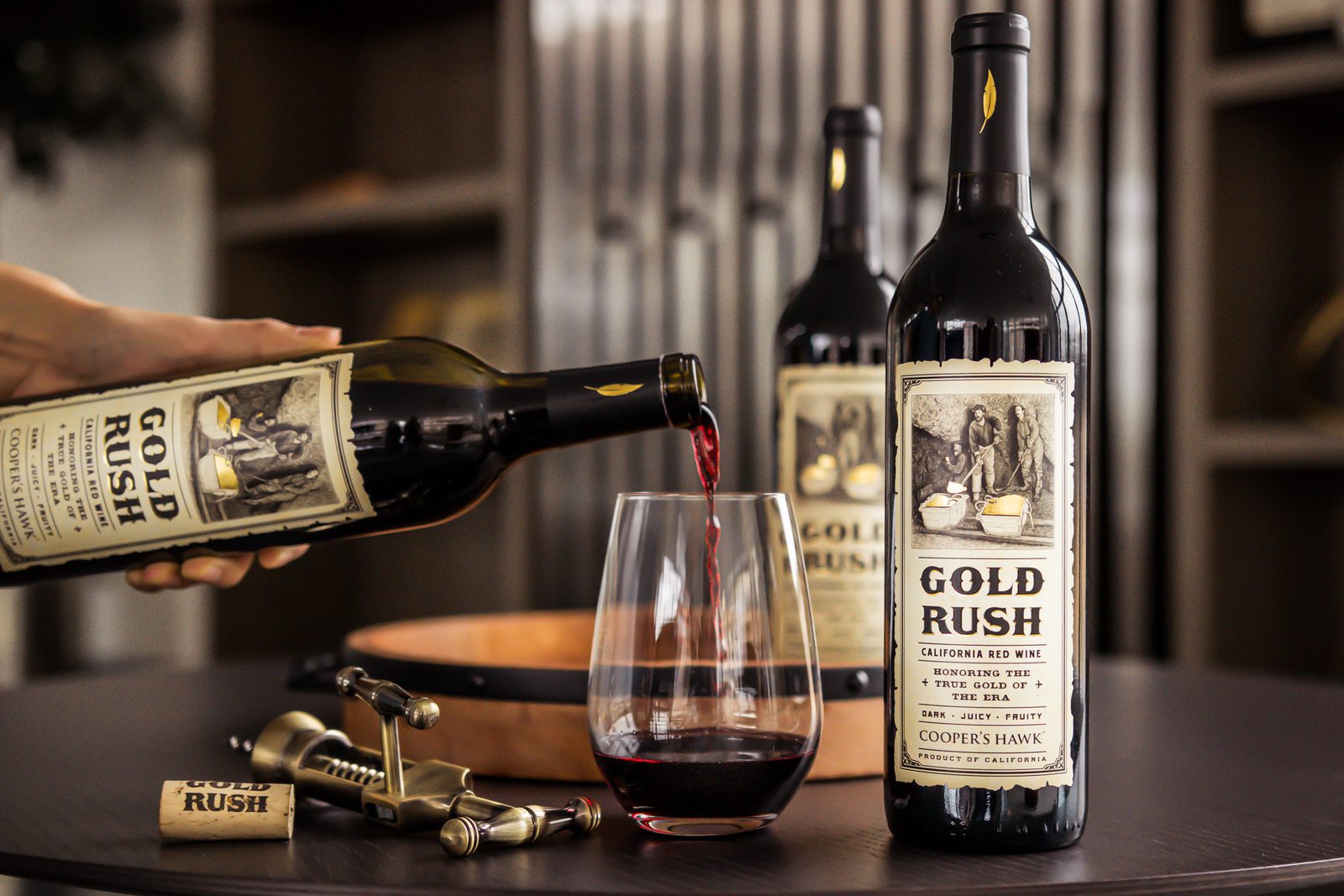 A bottle of wine is being poured into a glass.