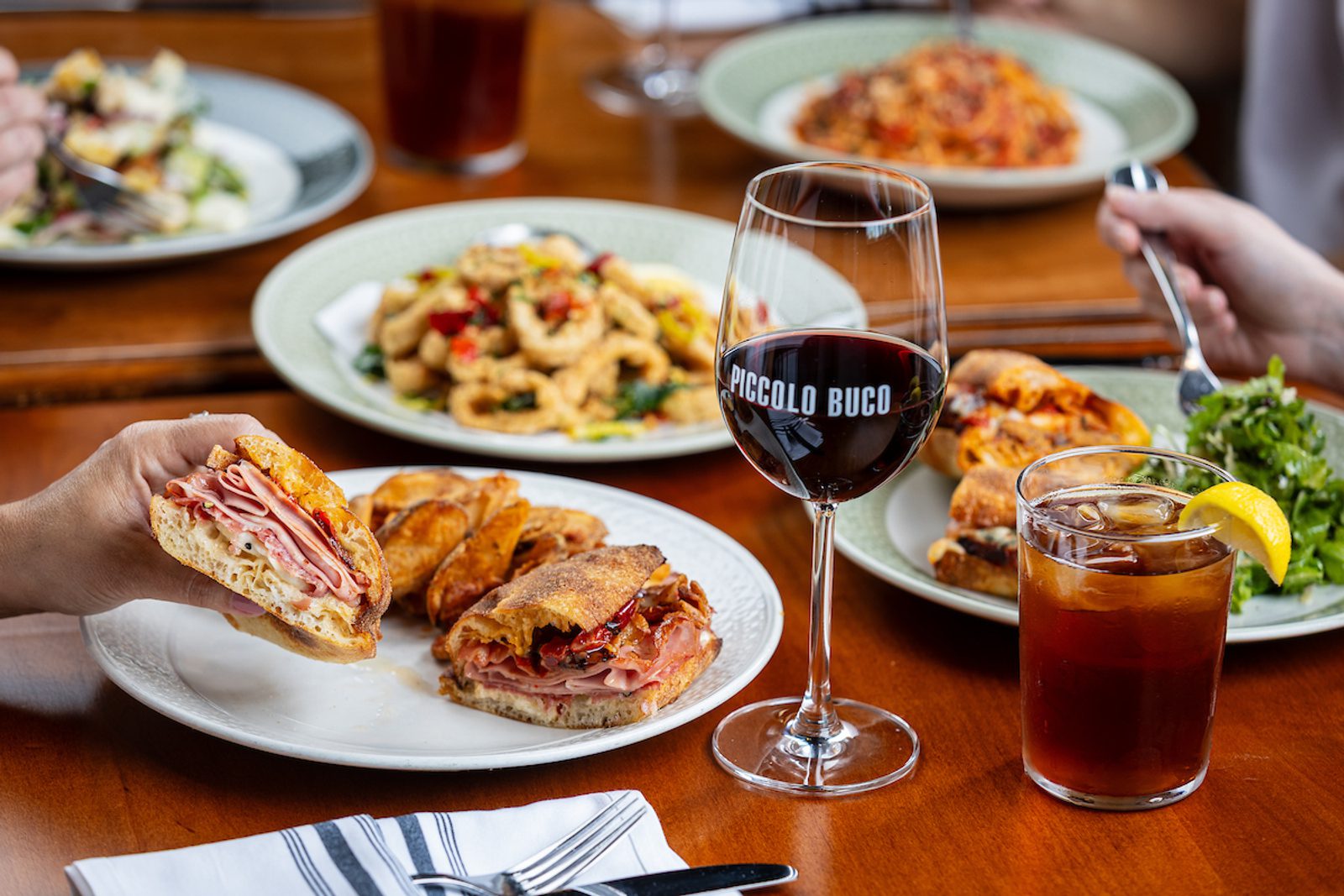 Piccolo Buco Lunch image with sandwich and other food and drinks