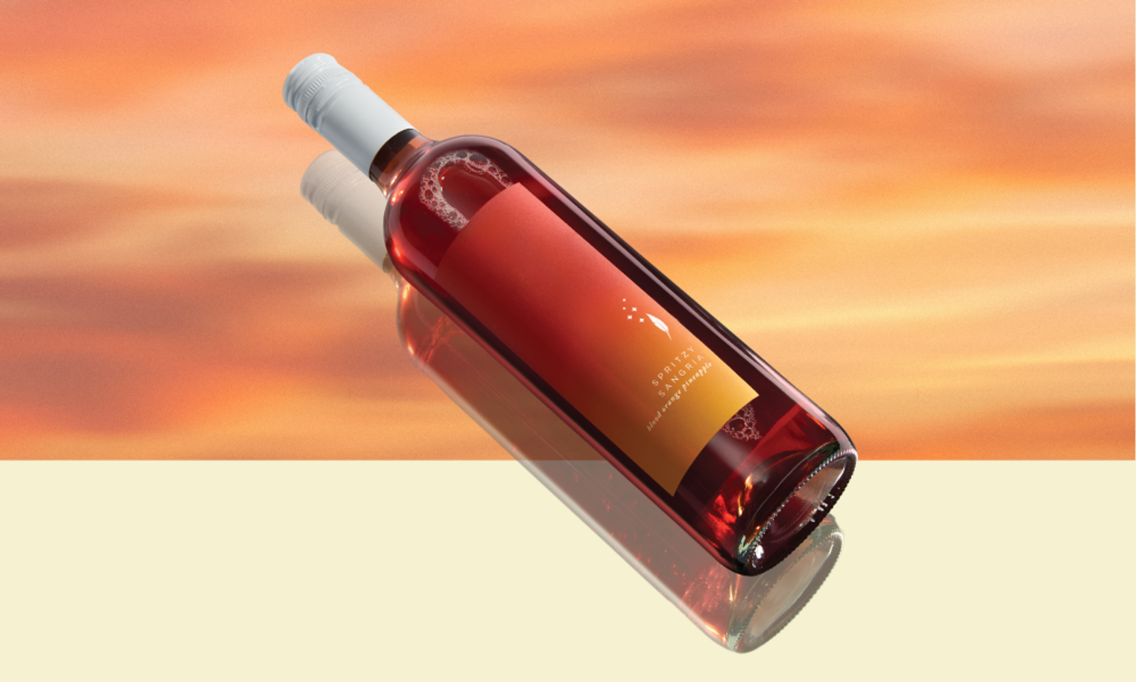 Rosé wine bottle on its side with an orange-gradient label and white cap, reflected on a surface against a sunset background