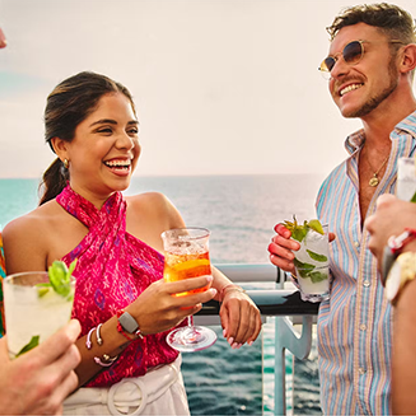 Image of people celebrating with drinks on cruise ship