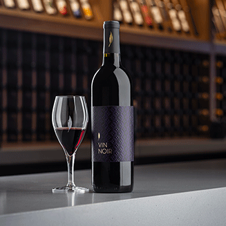 Vin Noir Image with glass of wine and bottle in TR