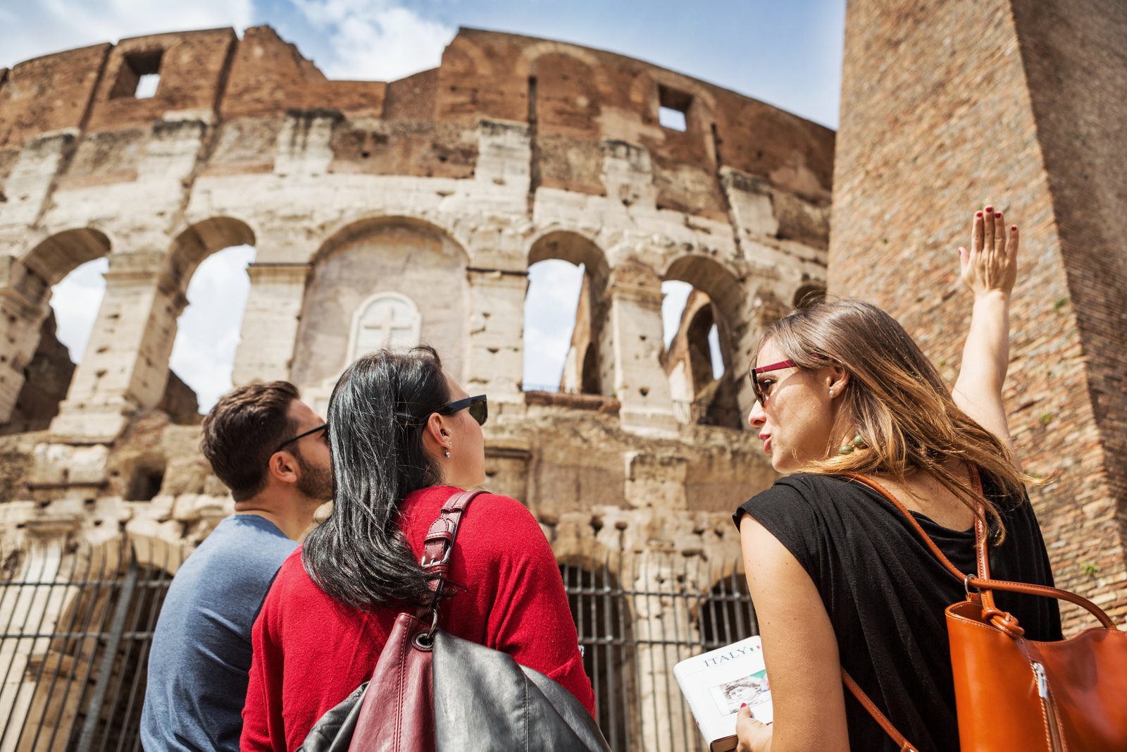 Tourists looking at the colossion in rome, italy.