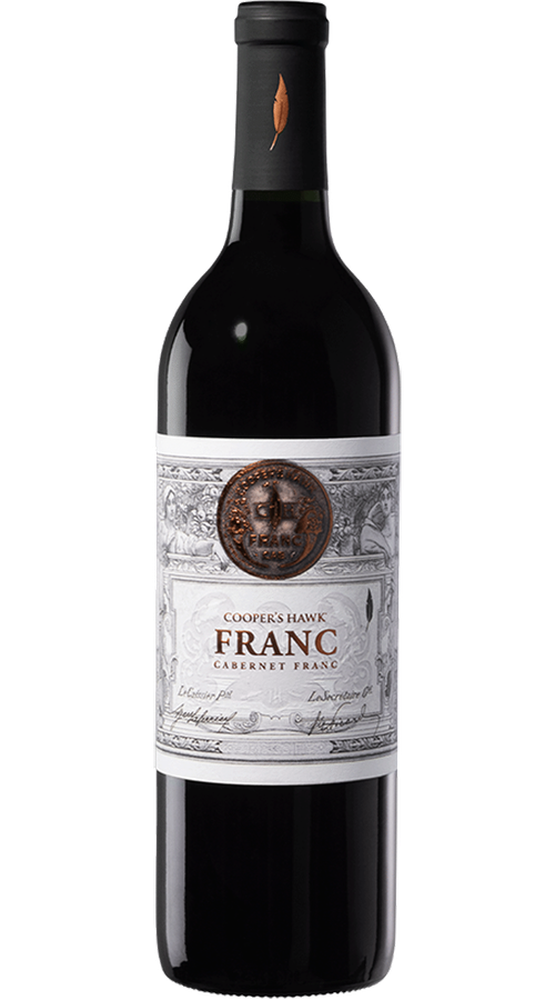 Bottle of Cooper’s Hawk Franc Cabernet Franc wine with dark glass, black capsule, and ornate white label on a green background