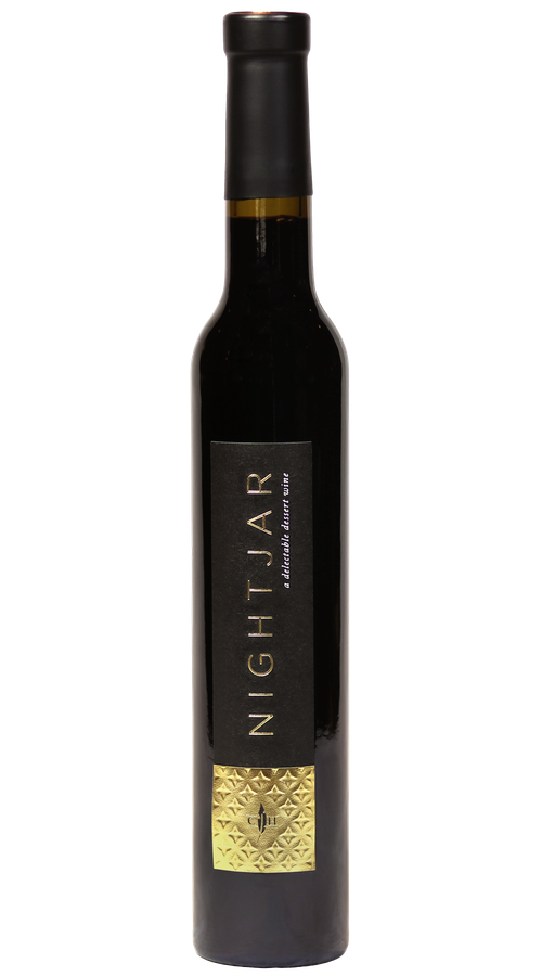A bottle of Nightjar wine with a black and gold label