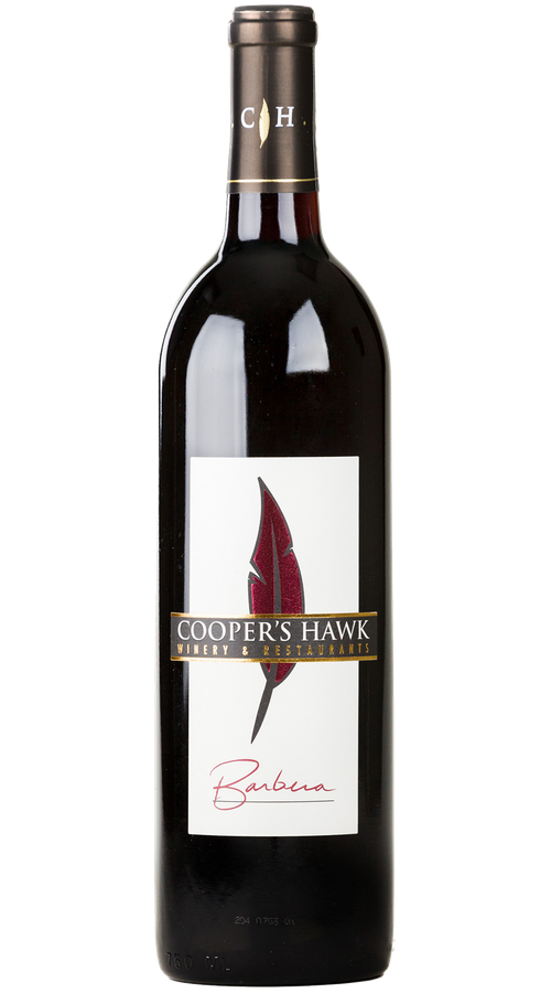 A bottle of red wine with a white label that has a feather on it.